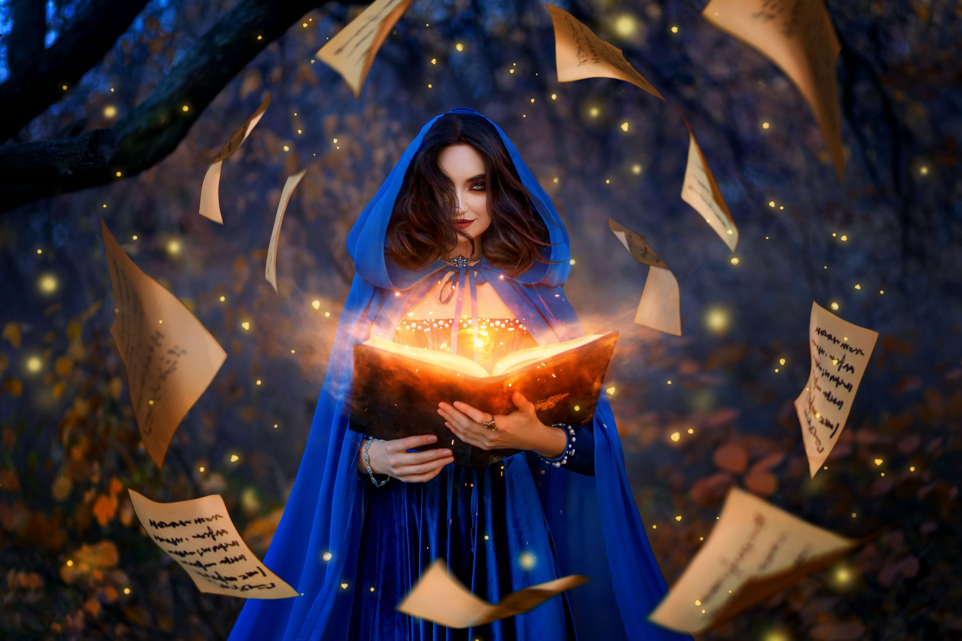 Fantasy woman witch magician in hood holds in hands magic book, bright orange light spells, wind scatters fall sheets paper page levitation. Girl sorceress. Medieval cloak blue dress magician costume. Fantasy woman witch magician in hood holds in hands magic book, bright orange light spells, wind scatters fall sheets paper page levitation. Girl sorceress. Medieval cloak blue dress magician costume.