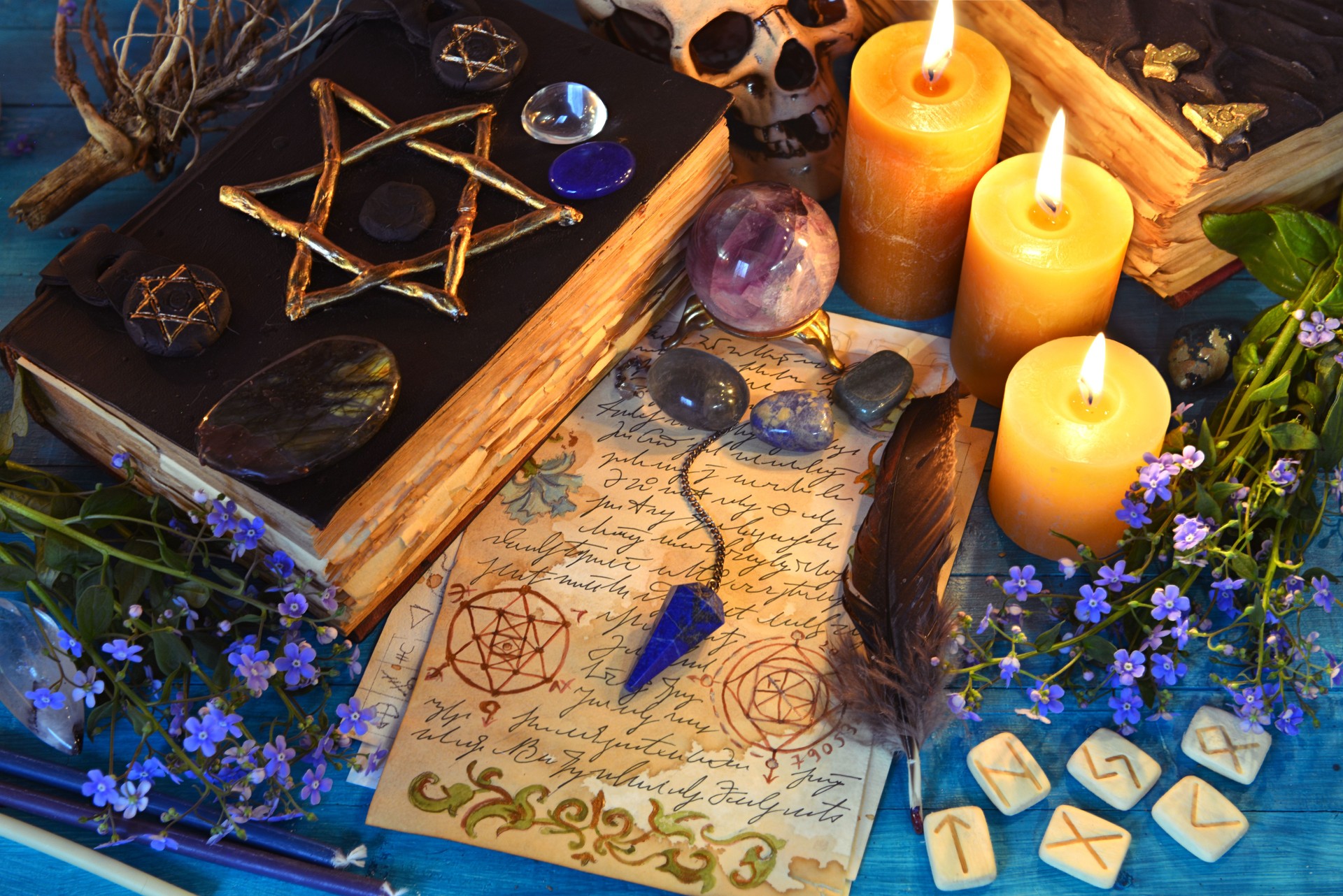 Black magic book of spells, runes and candles on ritual witch table. Occult, esoteric and fortune telling still life. Mystic background with vintage objects Black magic book of spells, runes and candles on ritual witch table. Occult, esoteric and fortune telling still life. Mystic background with vintage objects