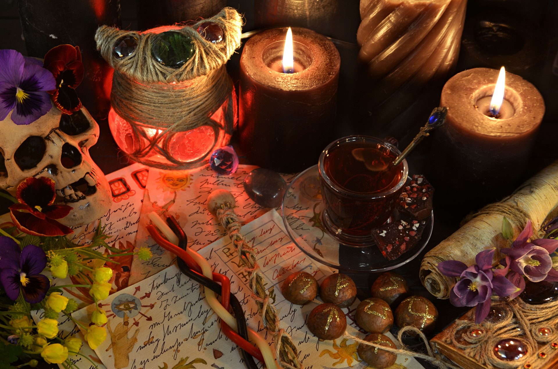Still life with skull, magic wands, manuscript and candles on witch ritual table. Occult, esoteric and witchcraft concept. Mystic background with vintage objects Still life with skull, magic wands, manuscript and candles on witch ritual table. Occult, esoteric and witchcraft concept. Mystic background with vintage objects